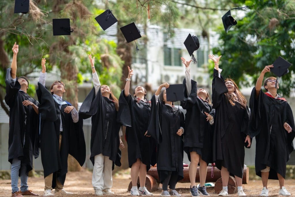 Photo of graduates tossing hats